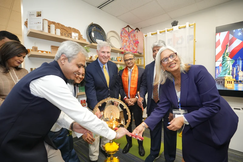 Guests participate in traditional lamp lighting in front of the product showcase.