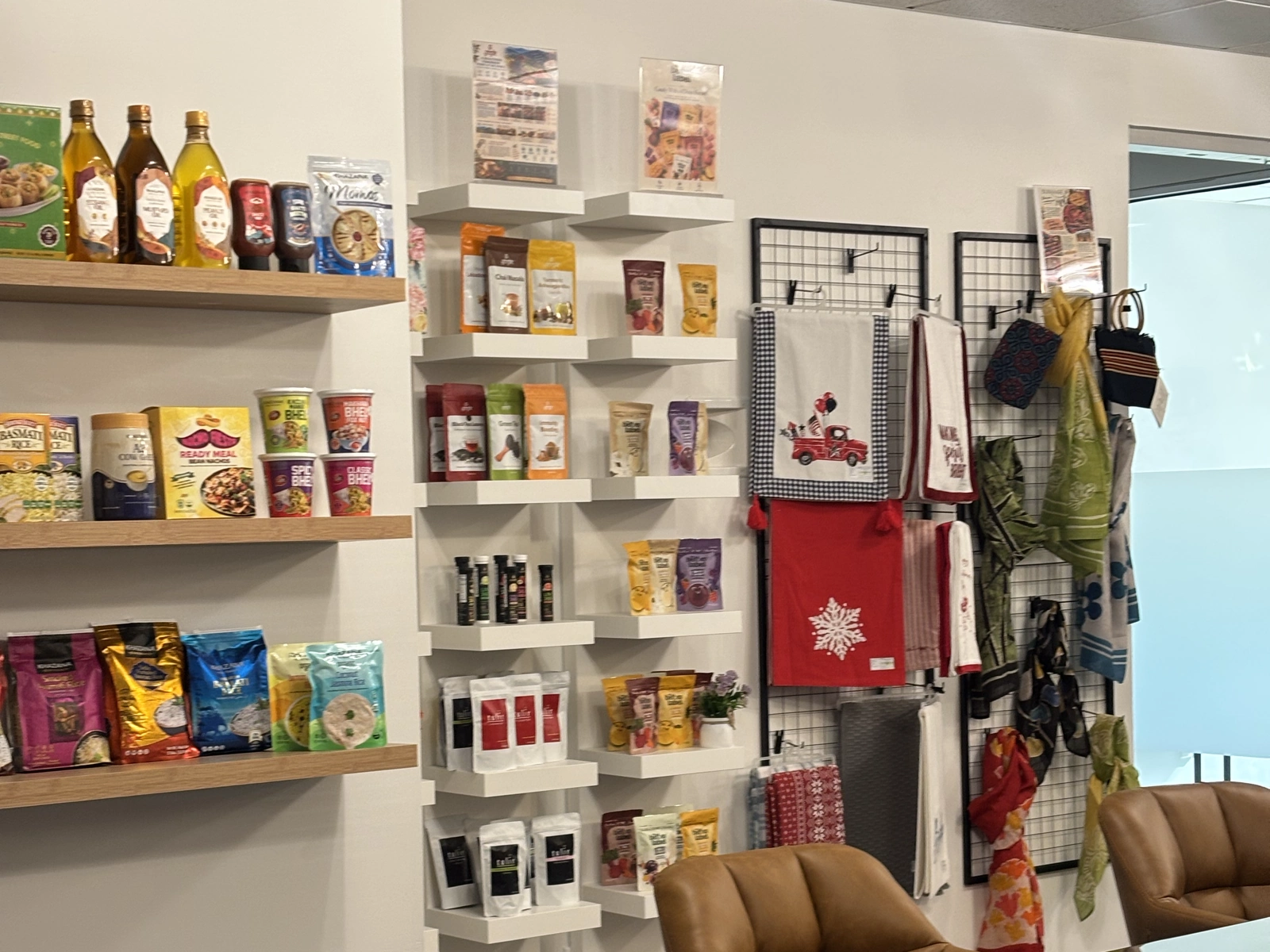 Packaged Indian foods and textiles arranged on shelves and display racks at USICC.